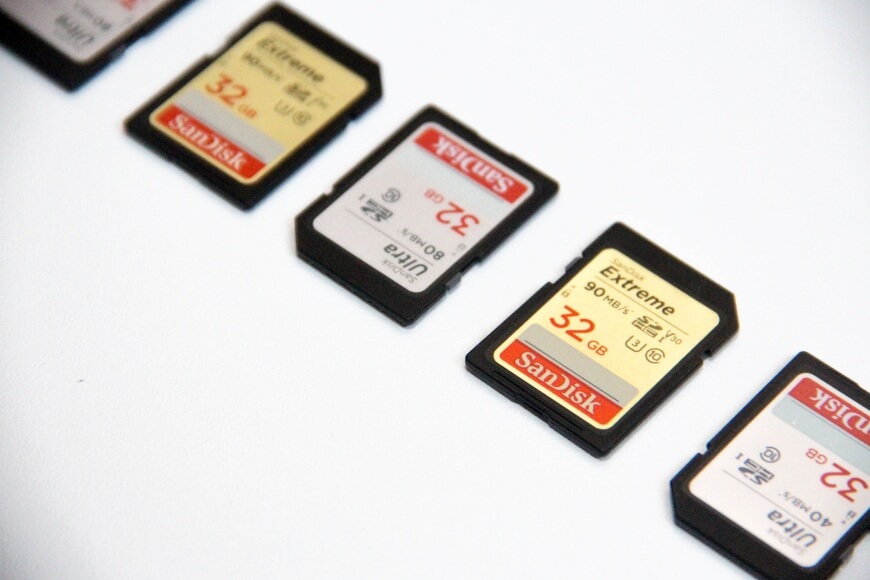 A row of sd cards on a white surface.