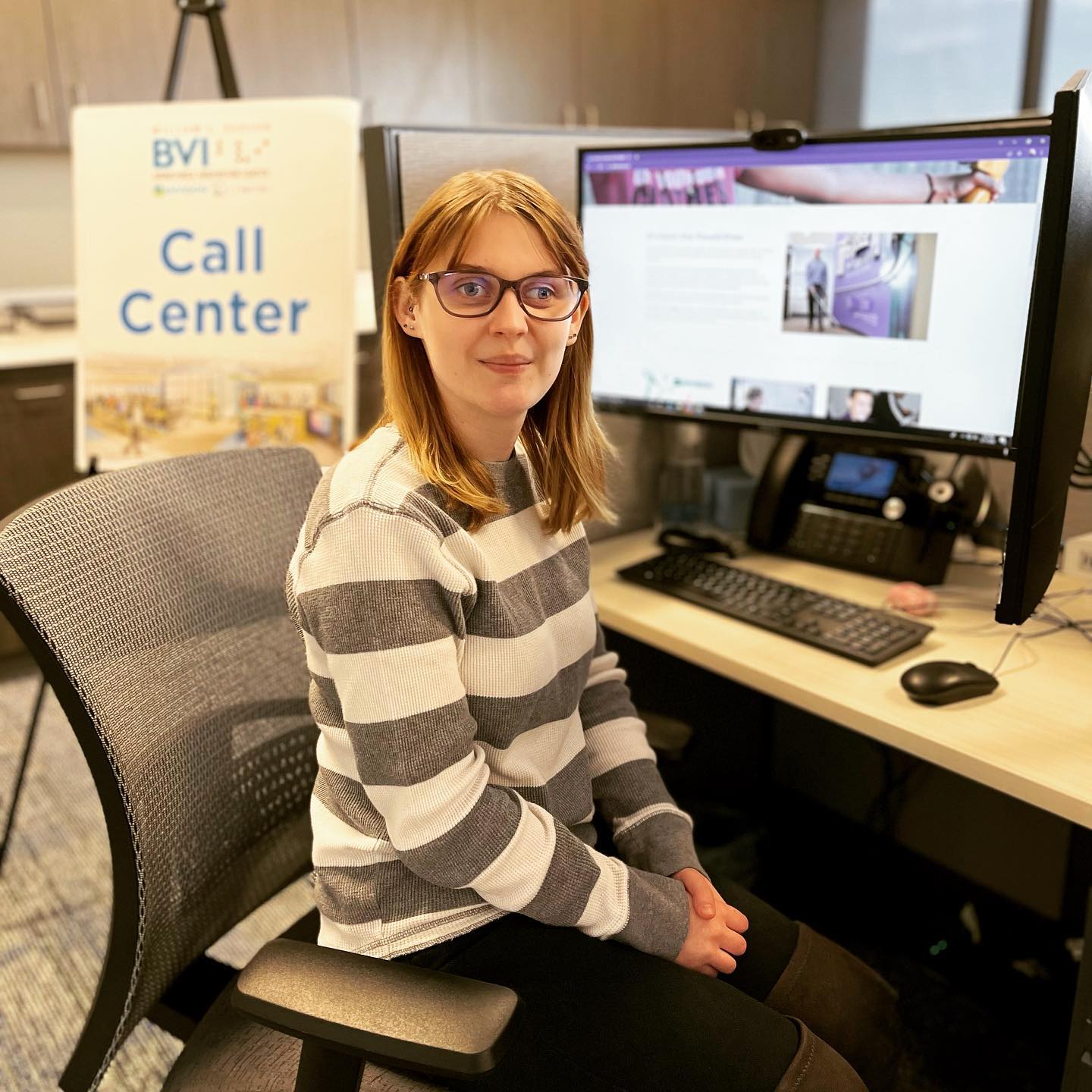 Alison sitting at her former desk at the Envision Workforce Innovation Center