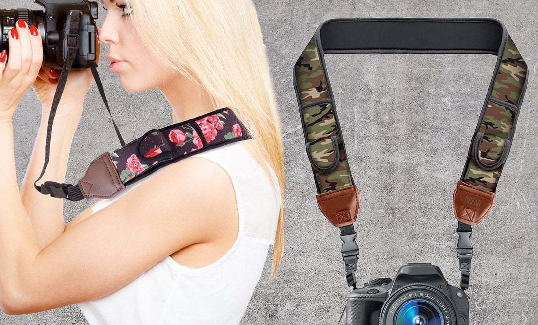 blonde girl looks through camera viewfinder while wearing fashionable camera strap
