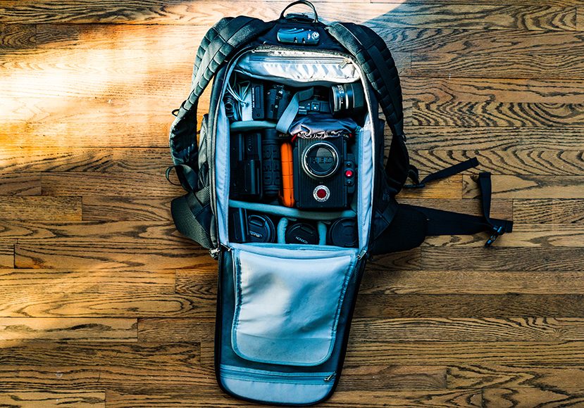 A backpack is sitting on a wooden floor.