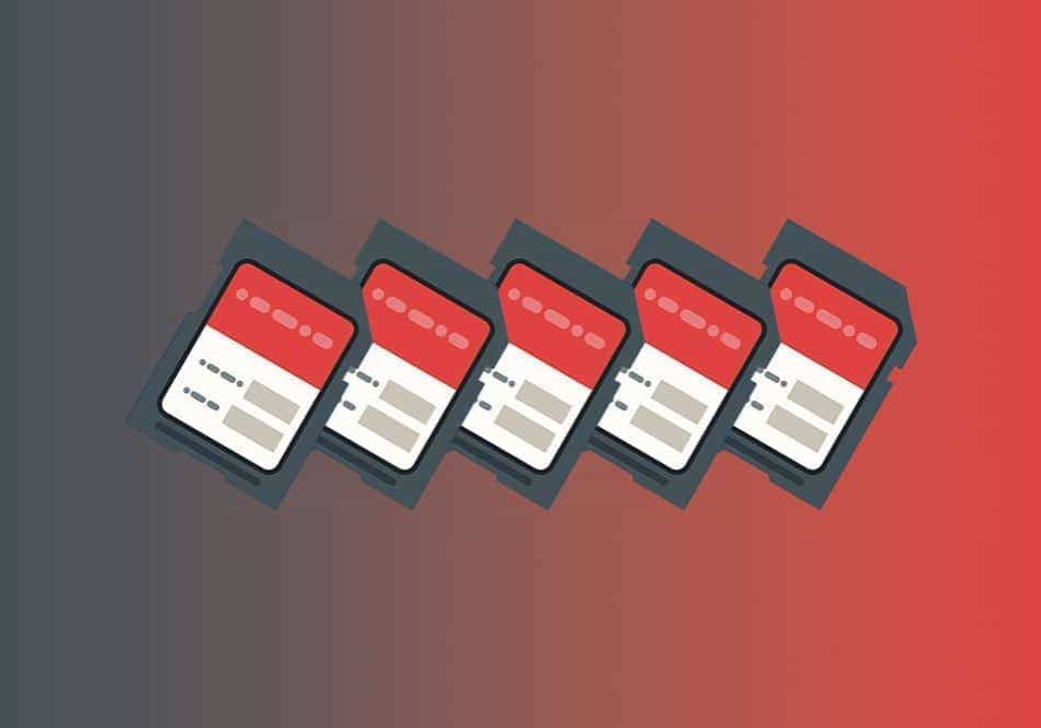 four sd cards on a red background.