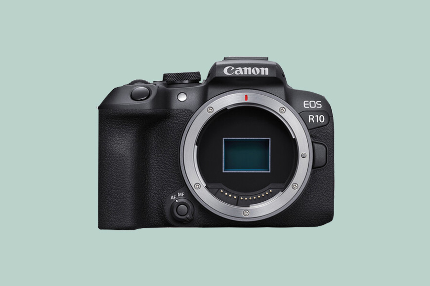 A Canon EOS R10 camera on a green back ground.