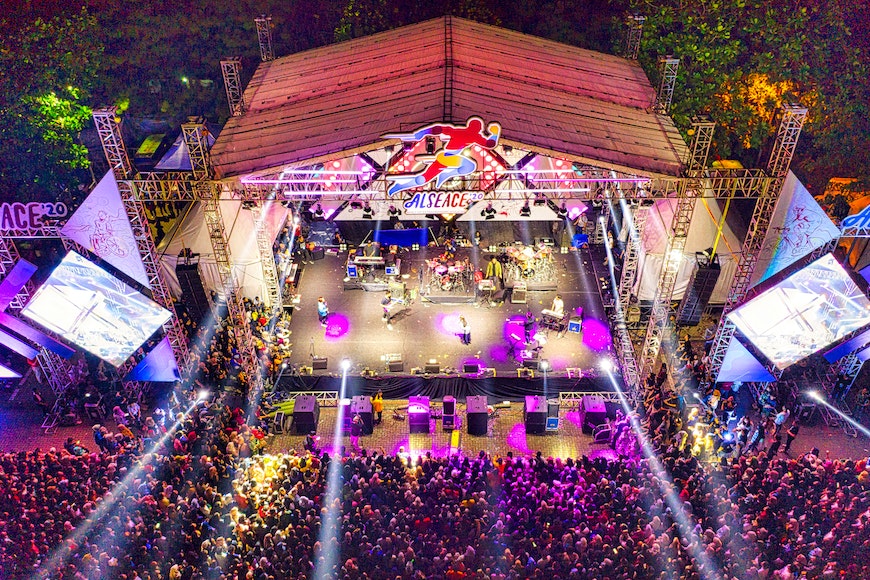 an aerial view of a concert stage at night.