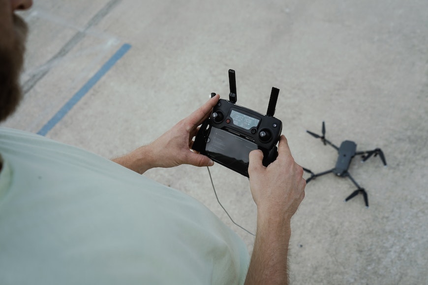 a man holding a remote control drone.