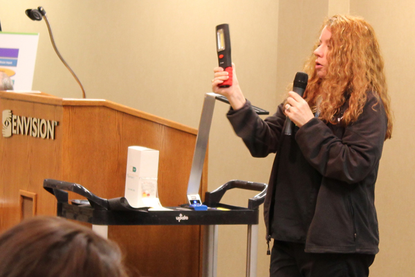 Andra, occupational therapy assistant, demonstrates how to use a magnifier at an Adult Support Group meeting.