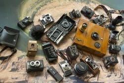 A group of old cameras on a table.