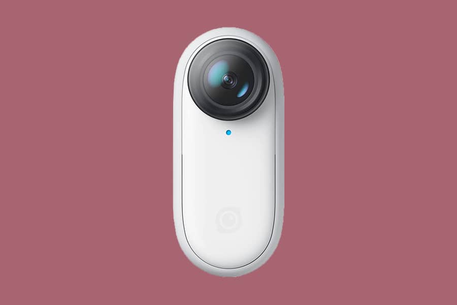 a Insta360 Go II camera on a pink back ground