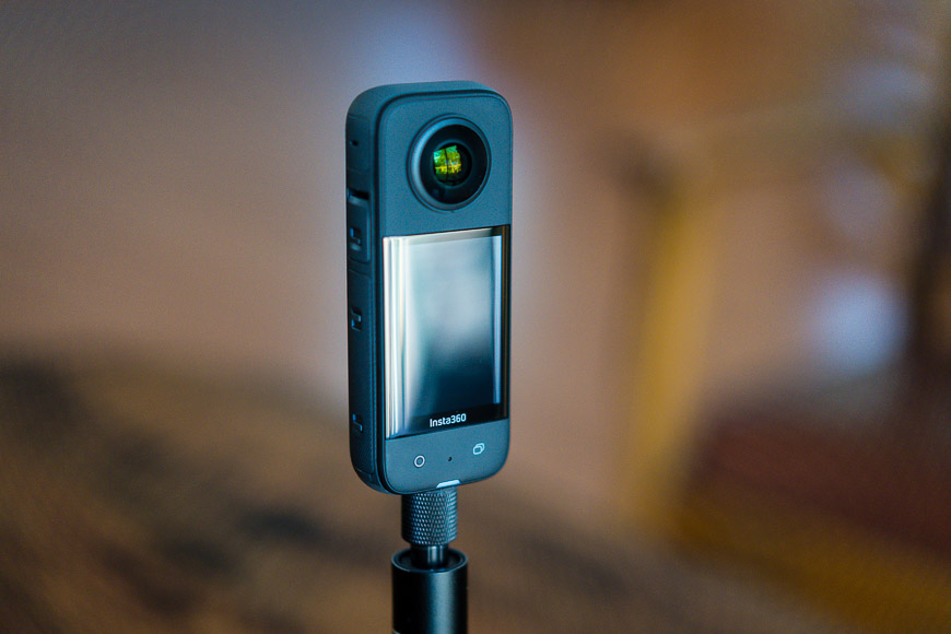A Insta360 X3 mounted on a selfie stick