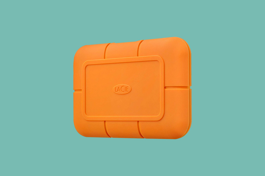 LaCie Rugged 500GB SSD hard drive on a green background.