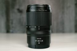 A close up of a Nikon camera lens on a table.