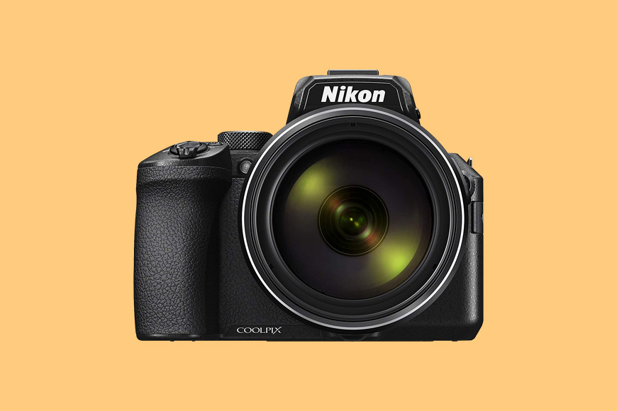 a Nikon P950 camera with a yellow background.