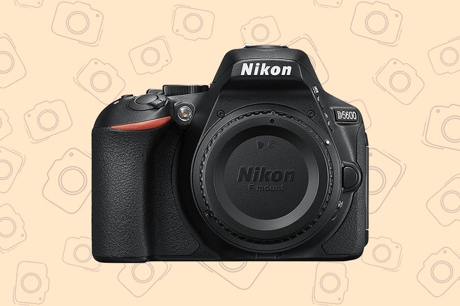 A Nikon D5600 CAMERA ON A TAN BACK GROUND WITH CAMERA PICTURES ON IT