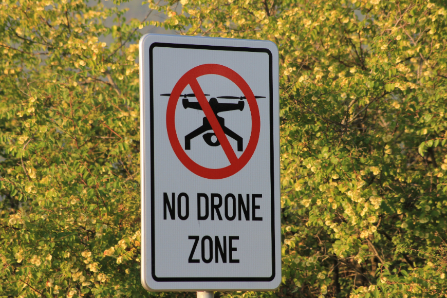 a sign that says no drone zone.