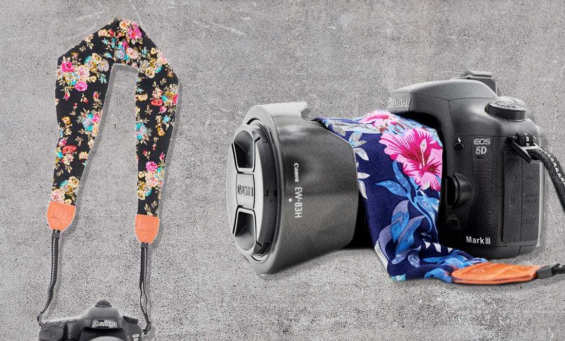 scarf style strap with floral design is attached to a DSLR
