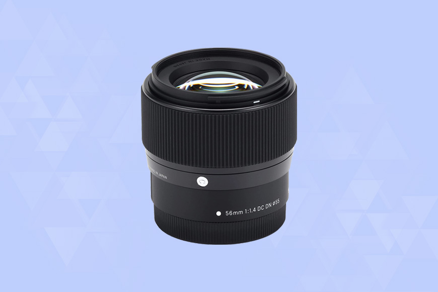 a Sigma 56mm F1.4 DC DN camera lens on a blue background.