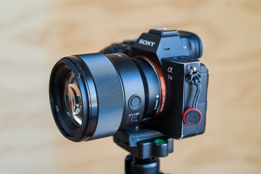 sony portrait lens attached to camera on tripod