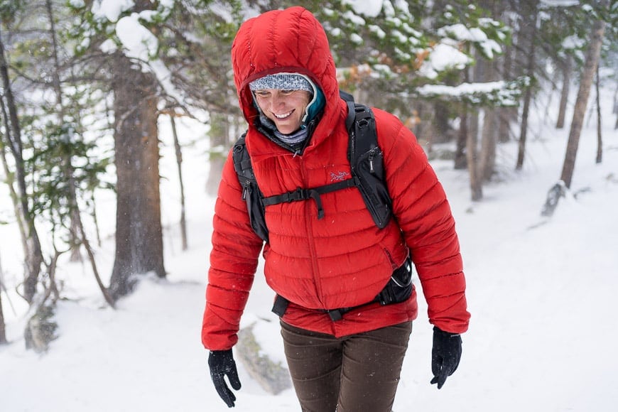 lady in red coat walking in snow