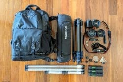A backpack with a camera, tripod, and other equipment.