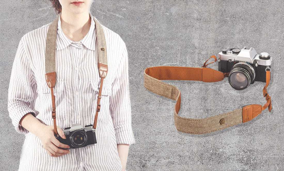 vintage style camera strap worn by woman