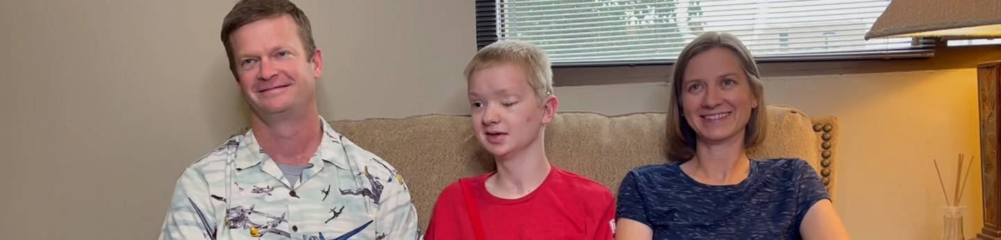 Caleb sits in the middle of his dad, Aaron (left) and his mom, Kim (right)