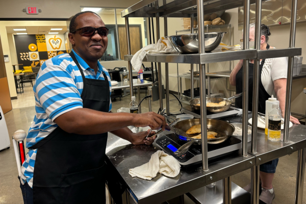 Johnson Riungu, Envision employee, cooking in the kitchen at NICHE.