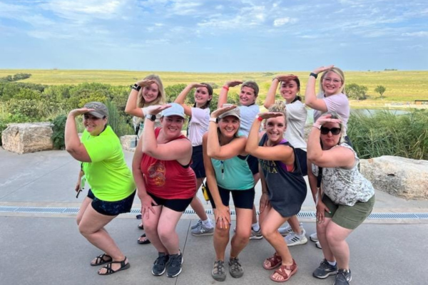 A group of Delta Gammas posing for a photo at camp.